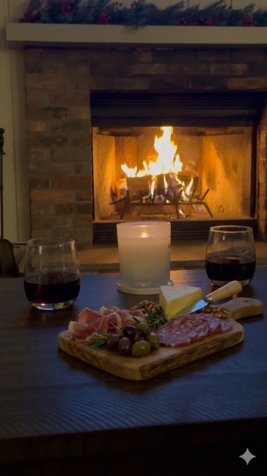 Wine and a charcuterie board in front of the roaring fireplace